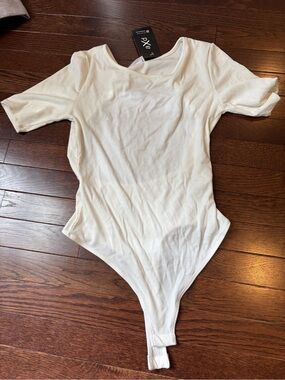LE LIS COLLECTION: White Ribbed One-Piece Bodysuit